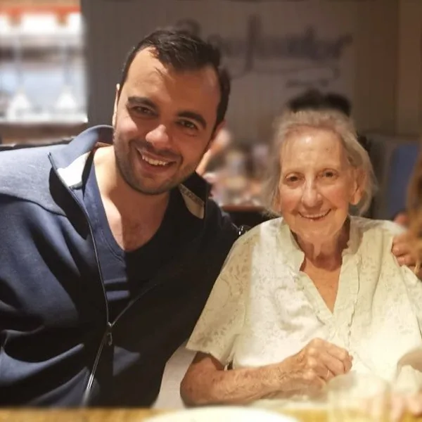 Andy with his grandmother Madge, the two of them smiling together.